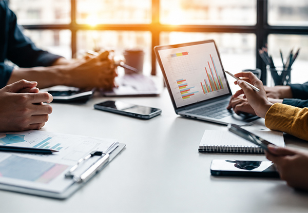 Professionals reviewing financial reports and investment data