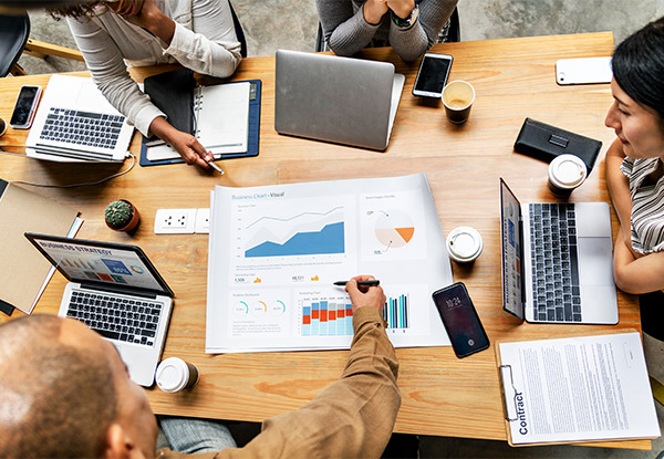 Business professionals reviewing investment reports and financial data